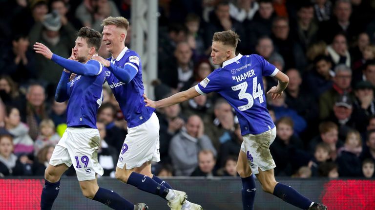 Oldham Athletic's Callum Lang (left) celebrates scoring his side's second goal of the game with team mates during the Emirates FA Cup, third round match at Craven Cottage, London.