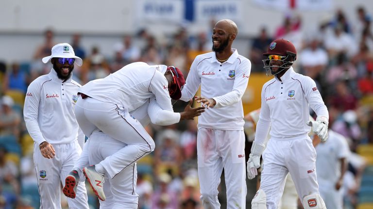 Roston Chase celebrates the fall of another England wicket in Barbados