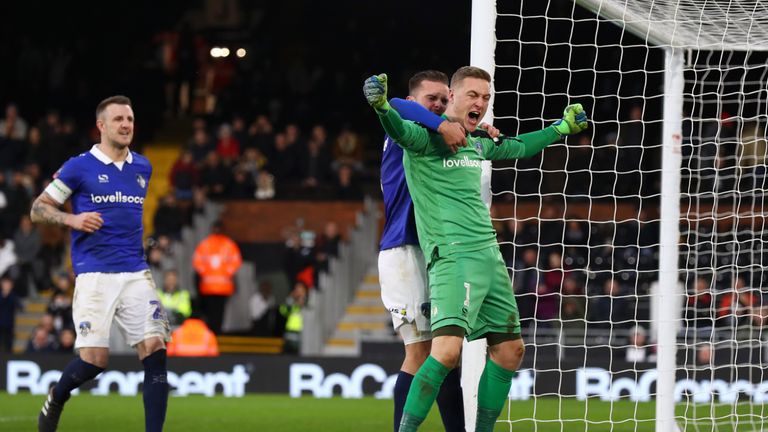 Daniel Iversen of Oldham Athletic celebrates with team mates after saving a penalty shot from Aleksandar Mitrovic of Fulham (not pictured) during the FA Cup Third Round match between Fulham and Oldham Athletic at Craven Cottage on January 6, 2019 in London, United Kingdom