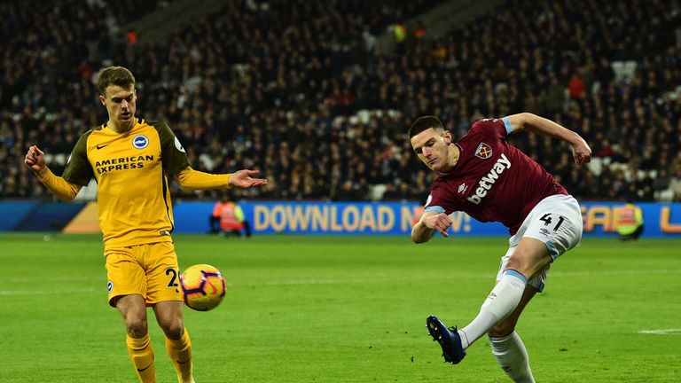 Declan Rice (R) clears the ball 