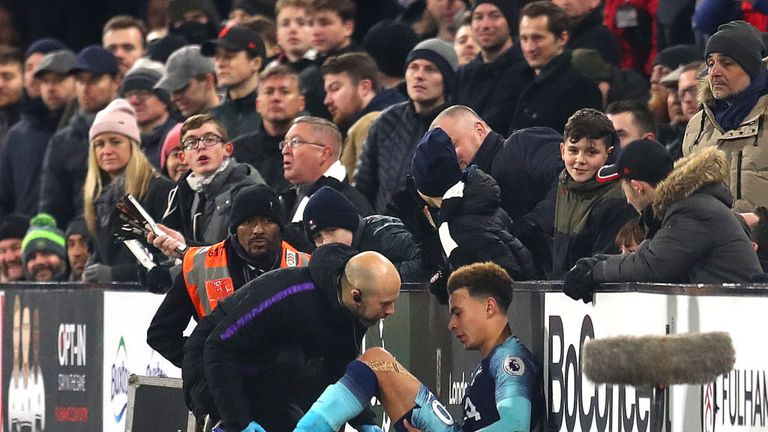 Dele Alli receives treatment before being substituted against Fulham