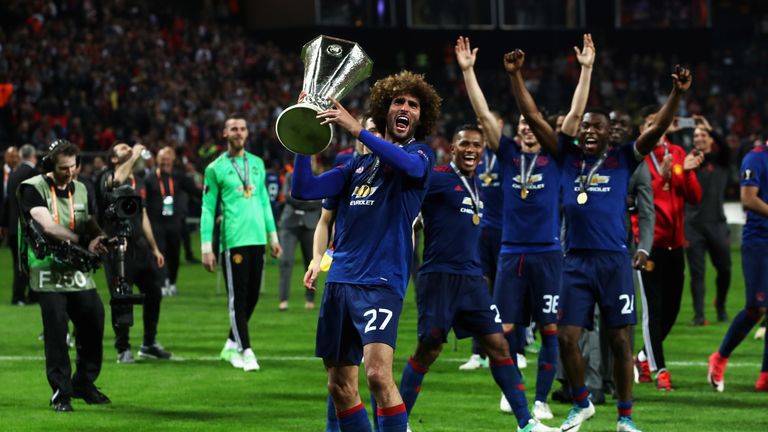 Marouane Fellaini holds up the Europa League trophy