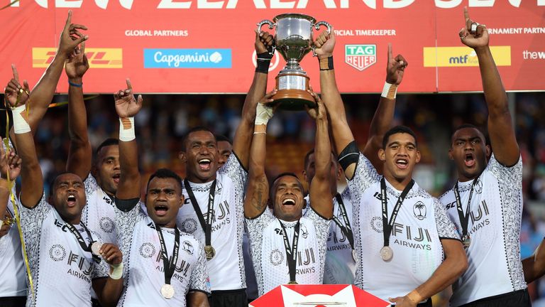 Fiji players celebrate with the trophy after winning the cup final of the World Rugby Sevens Series match between the US and Fiji at Waikato Stadium in Hamilton on January 27, 2019.