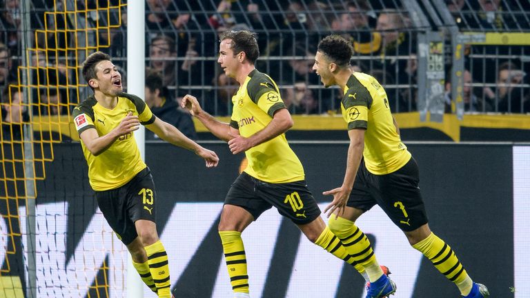 Raphael Guerreiro (left) celebrates his goal with Mario Gotze and Jadon Sancho