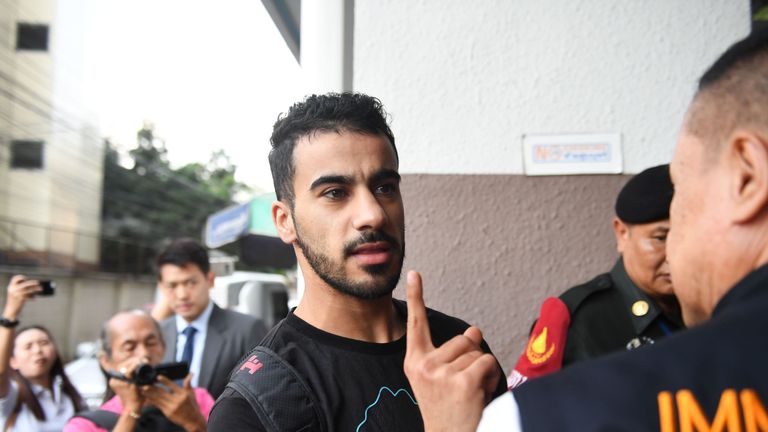 Hakeem Alaraibi a former Bahrain national team footballer with refugee status in Australia, is escorted by immigration police to a court in Bangkok