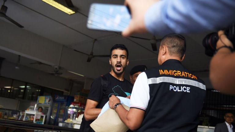 Hakeem Alaraibi, a former Bahrain national team is escorted by immigration police to a court in Bangkok on December 11, 2018.