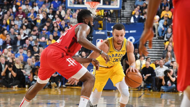 Stephen Curry of the Golden State Warriors handles the ball against James Harden of the Houston Rockets