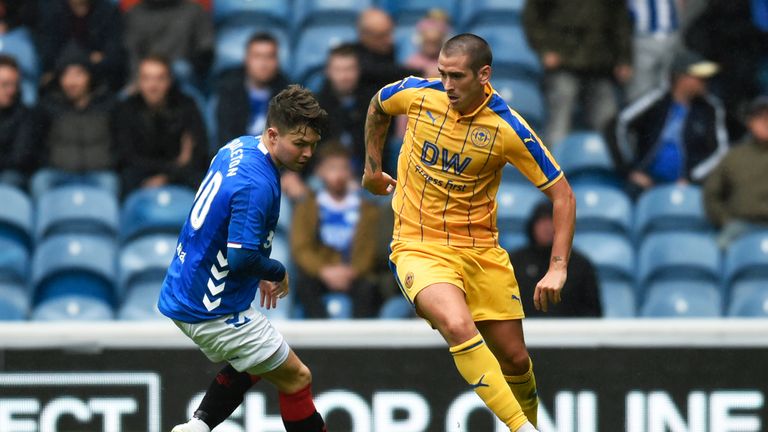 Rangers' Glenn Middleton (L) in action with Wigan's Jamie Walker.