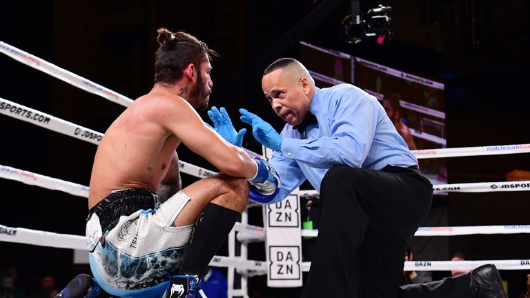 Jorge Linares of Venezuela remains on the ground after being knocked out by Pablo Cesar Cano of Mexico during their junior welterweights fight 