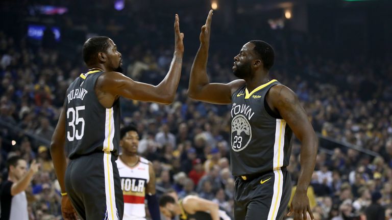Kevin Durant high fives Draymond Green during their game against the New Orleans Pelicans
