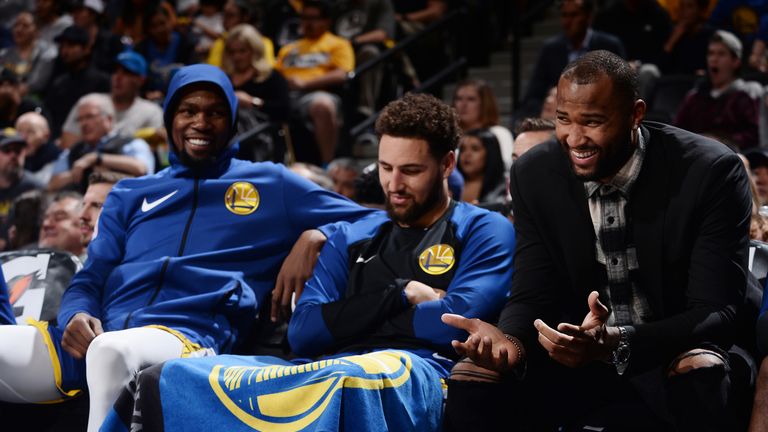 Kevin Durant #35, Klay Thompson #11, and DeMarcus Cousins #0 of the Golden State Warriors react to a play during the game against the Denver Nuggets on October 21, 2018 at the Pepsi Center in Denver, Colorado.