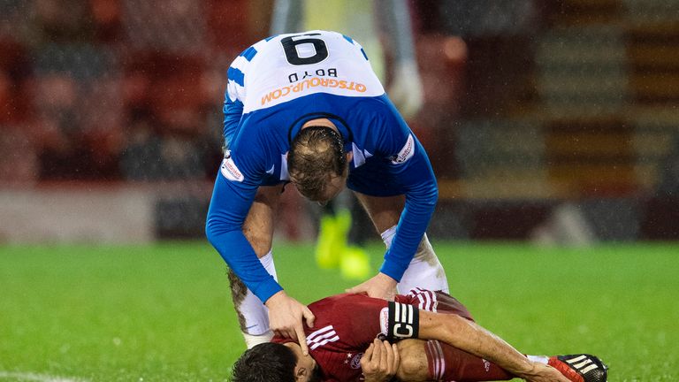 Kilmarnock's Kris Boyd checks on Aberdeen's Graeme Shinnie after his late tackle earned the striker a red card
