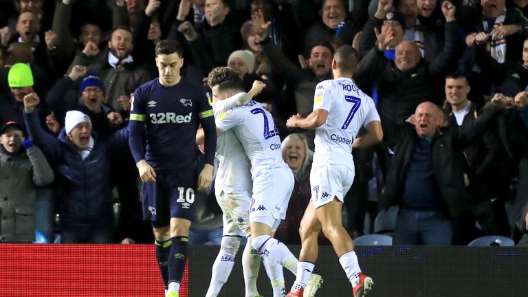 Leeds United's Jack Harrison (centre) celebrates scoring his side's second goal of the game with his team mates as Derby County's Tom Lawrence appears dejected during the Sky Bet Championship match at Elland Road, Leeds.