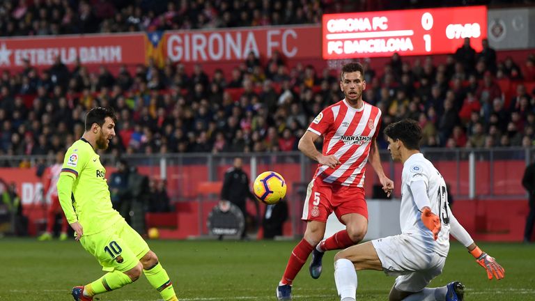 Lionel Messi' dinked finish stretched Barcelona's lead at the Montilivi Stadium