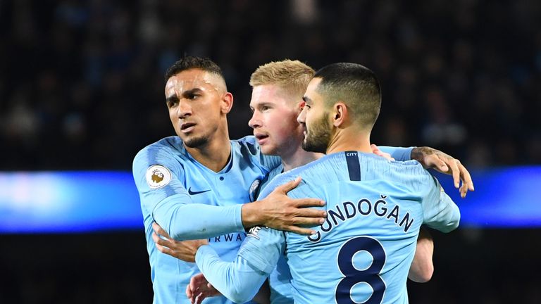 MANCHESTER, ENGLAND - JANUARY 14:  Kevin De Bruyne of Manchester City celebrates with teammates Danilo and Ilkay Gundogan of Manchester City as Conor Coady of Wolverhampton Wanderers (not pictured) scores their team's third goal for an own goal during the Premier League match between Manchester City and Wolverhampton Wanderers at Etihad Stadium on January 12, 2019 in Manchester, United Kingdom.  (Photo by Clive Mason/Getty Images)