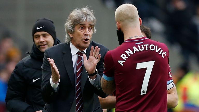 Manuel Pellegrini speaks with Marko Arnautovic during a break in play