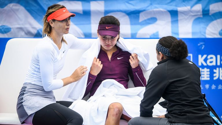 Maria Sharapova (L) of Russia talks with Wang Xinyu (C) of China who retired hurt after their women's singles second round match of the Shenzhen Open tennis tournament in Shenzhen in China's southern Guangdong province on January 2, 2019. 