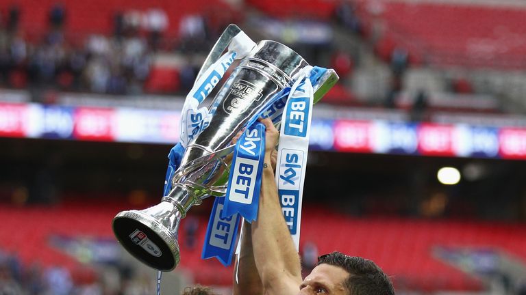 Tommy Smith of Huddersfield Town and Mark Hudson of Huddersfield Town celebrate with The Championship play off trophy after the Sky Bet Championship play off final between Huddersfield and Reading at Wembley Stadium on May 29, 2017 in London, England