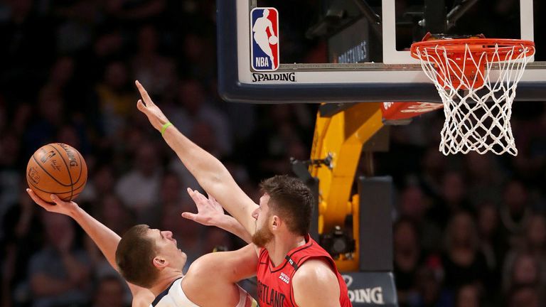 Nikola Jokic of the Denver Nuggets throws up a shot against Jusuf Nurkic of the Portland Trail Blazers