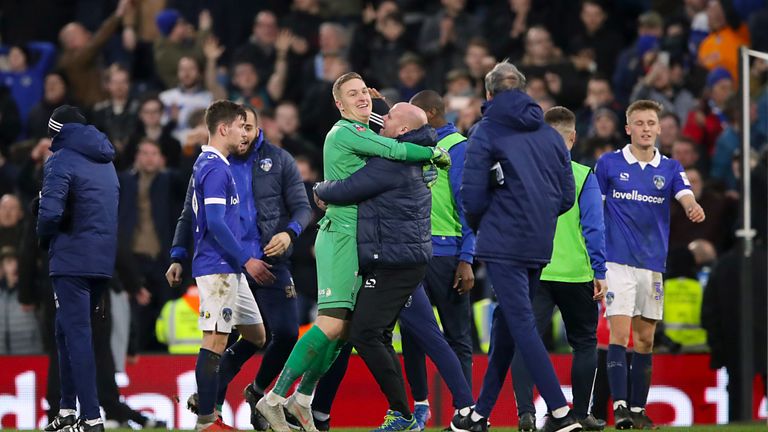 Oldham players and staff celebrate beating Fulham 2-1 away in FA Cup R3