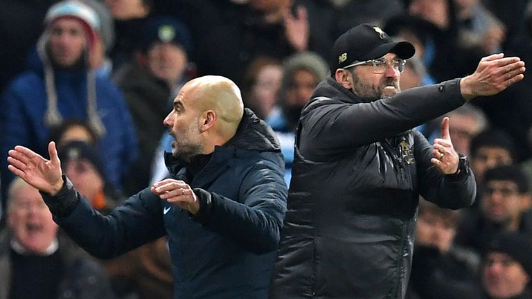 Liverpool's German manager Jurgen Klopp (R) and Manchester City's Spanish manager Pep Guardiola (L) gesture on the touchline during the English Premier League football match between Manchester City and Liverpool at the Etihad Stadium in Manchester, north west England, on January 3, 2019