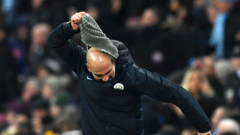 Pep Guardiola pulls off his snood in frustration