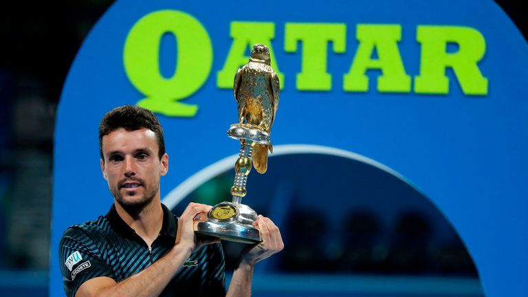 Spain's Roberto Bautista Agut poses with the trophy after winning the ATP Qatar Open tennis final match against Czech Republic's Tomas Berdych (unseen) in Doha on January 5, 2019.