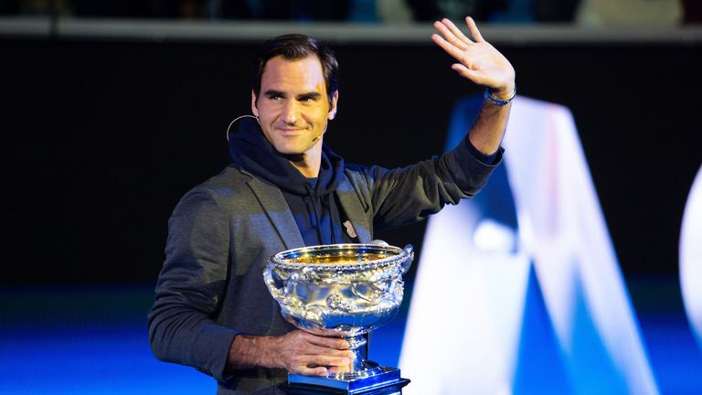 Roger Federer of Switzerland walks on stage with the Norman Brookes Challenge Cup during the Official Draw ahead of the 2019 Australian Open at Margaret Court Arena on January 10, 2019 in Melbourne, Australia