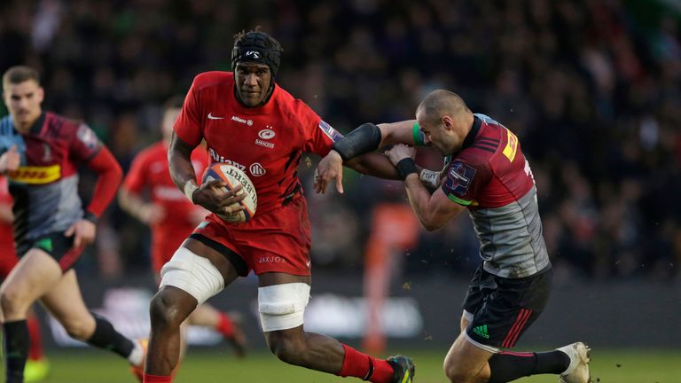 Saracens' Joel Kpoku fends off Harlequins' Ross Chisholm during their Premiership Rugby Cup clash at The Stoop.