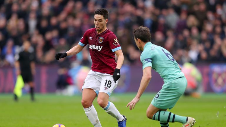 Samir Nasri takes on Laurent Koscielny at London Stadium