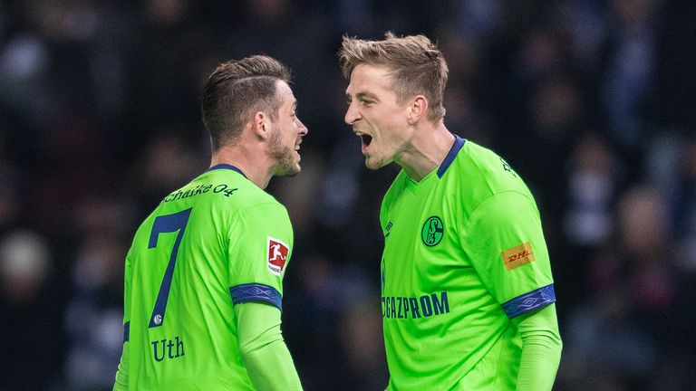 Mark Uth of FC Schalke 04 celebrates with team mate Bastian Oczipka 
