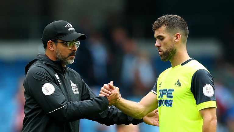 David Wagner, manager of Huddersfield Town shakes hands with Tommy Smith of Huddersfield Town after the Premier League match between Manchester City and Huddersfield Town at Etihad Stadium on August 19, 2018 in Manchester, United Kingdom.