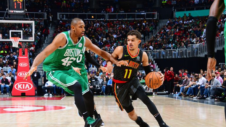  Trae Young #11 of the Atlanta Hawks handles the ball against Al Horford #42 of the Boston Celtics on January 19, 2019 at State Farm Arena in Atlanta, Georgia