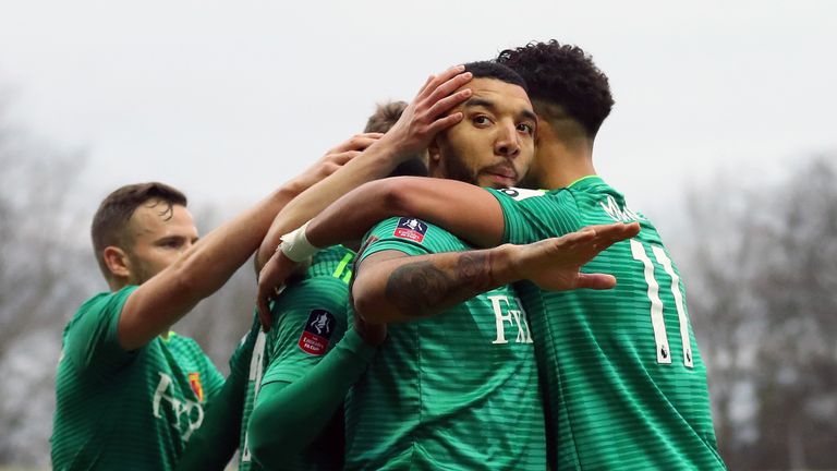 Troy Deeney of Watford celebrates with teammates after scoring his team's second goal during the FA Cup Third Round match between Woking and Watford at Kingfield Stadium on January 6, 2019 in Woking, United Kingdom