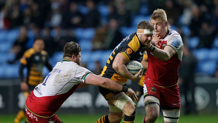 Thomas Young fending off Saints' defenders at the Ricoh Arena