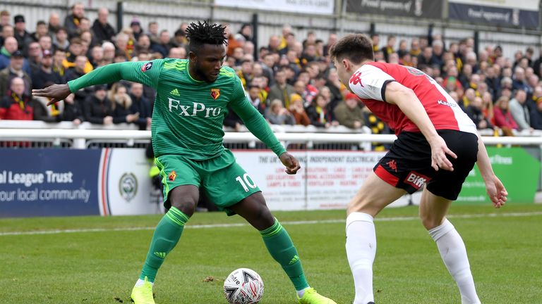 Isaac Success of Watford runs with the ball towards Jack Cook of Woking during the FA Cup Third Round match between Woking and Watford at Kingfield Stadium on January 6, 2019 in Woking, United Kingdom. 