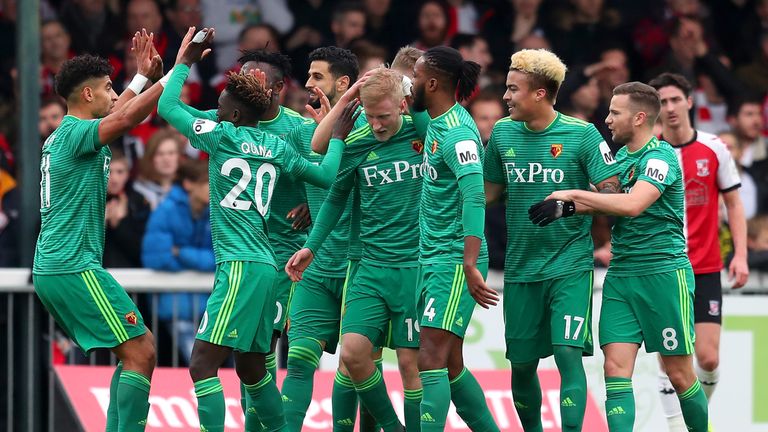 Will Hughes of Watford celebrates with teammates after scoring his team's first goal during the FA Cup Third Round match between Woking and Watford at Kingfield Stadium on January 6, 2019 in Woking, United Kingdom