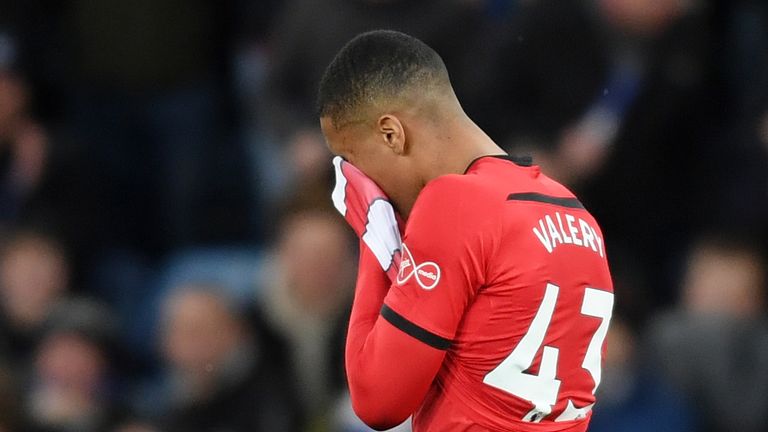 Yan Valery walks off the pitch after being shown a red card