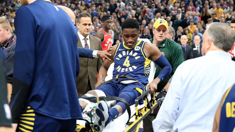An injured Victor Olapido is stretchered off the court during Indiana's clash with Toronto