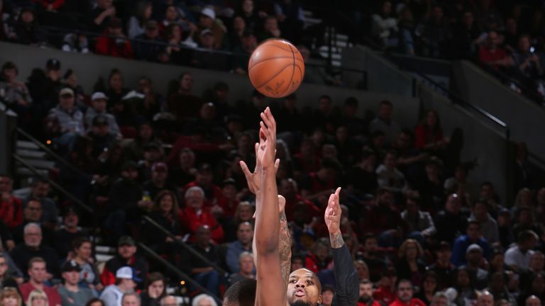 Damian Lillard fires a contested jump shot against Golden State