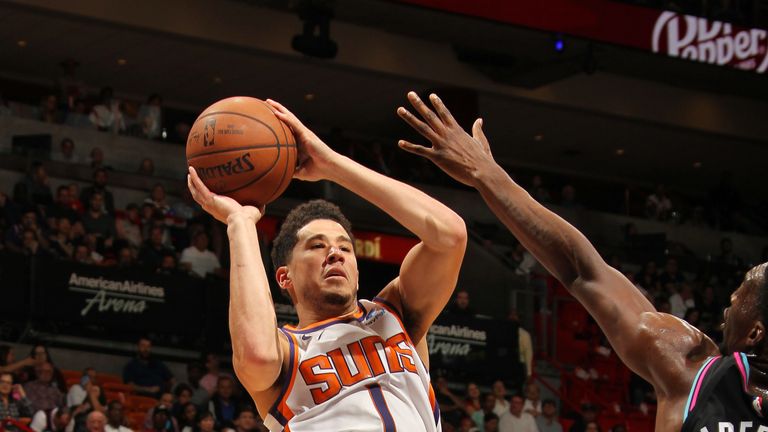 Devin Booker fires a fadeaway jumper against Miami