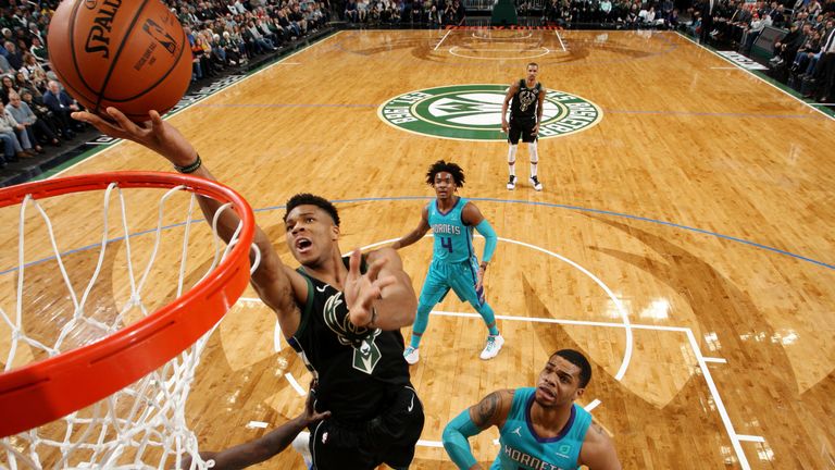Giannis Antetokounmpo outmuscles the Hornets defense to score an easy basket at the rim