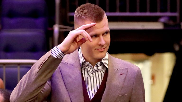 Kristaps Porzinis salutes fans at a Knicks event