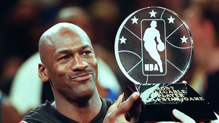 Michael Jordan lifts the All-Star Game MVP award