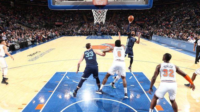 Mike Conley lofts a floater over DeAndre Jordan