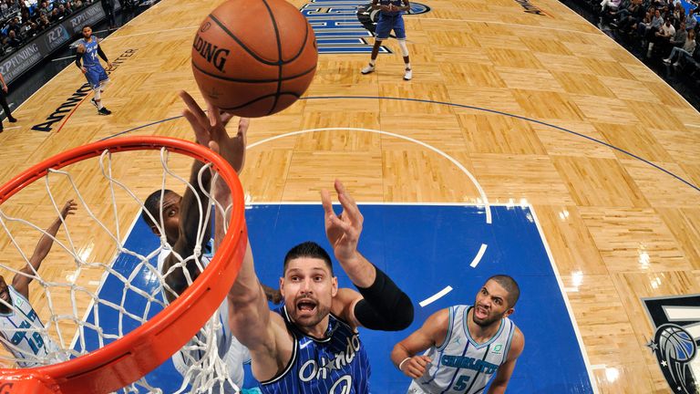 Nikola Vucevic grabs a rebound against Charlotte