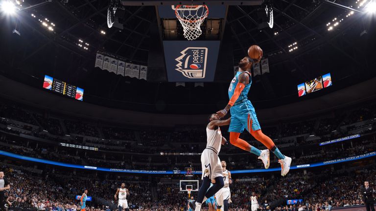 Paul George soars for an emphatic dunk in Denver