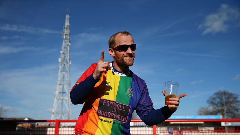 An Altrincham fan dons the multicoloured Football Against Homophobia shirt ahead of Saturday's match