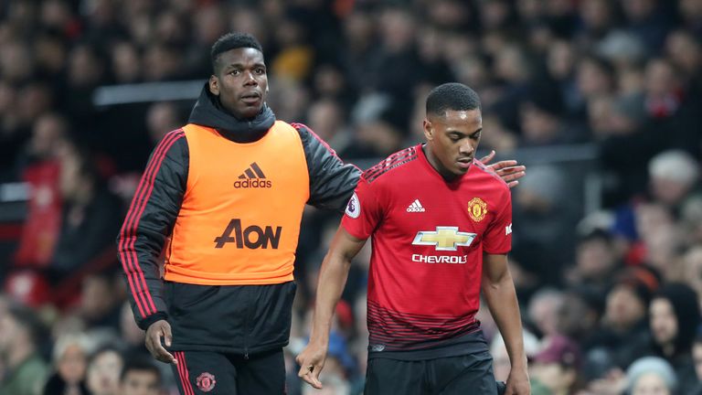 Manchester United's Paul Pogba consoles team-mate Anthony Martial as he walks off with an injury during a Premier League match at Old Trafford