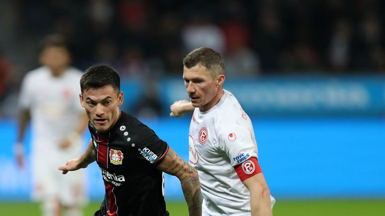 Charles Aranguiz of Bayer 04 Leverkusen breaks away from Oliver Fink of Fortuna Duesseldor